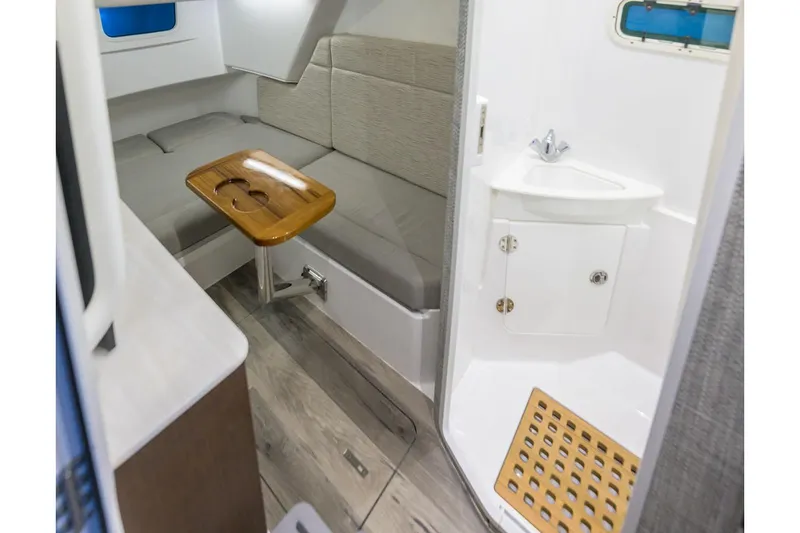 Slide: The Image of Manufacturer Provided Image: 2025 Everglades 375 Center Console cabin interior with seating and compact bathroom. - 9