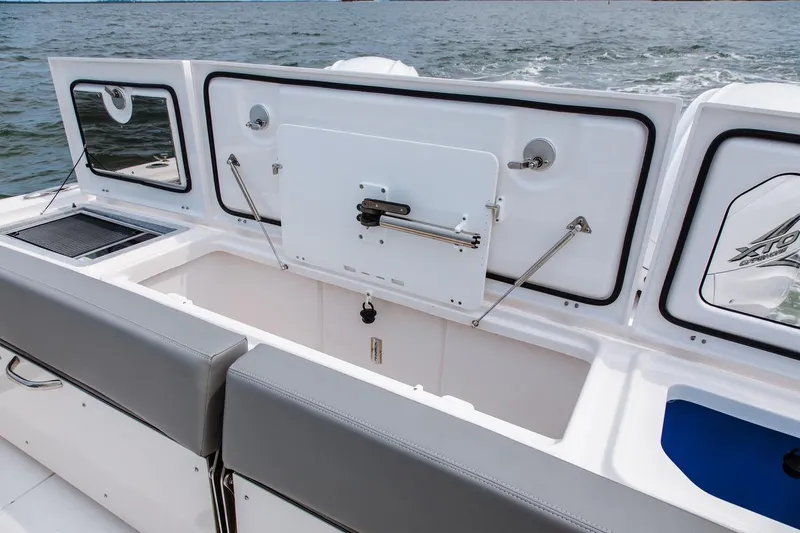 Slide: The Image of 2026 Everglades 395 Center Console boat interior with storage compartments open. - 16