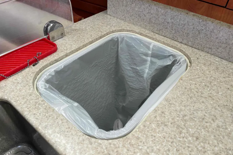 Slide: The Image of Dishes neatly stored in a 2010 Hunter 45 Center Cockpit kitchen cabinet. - 11