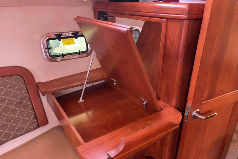 Slide: The Image of Interior of 2010 Hunter 45 Center Cockpit with cozy seating and wooden table. - 21
