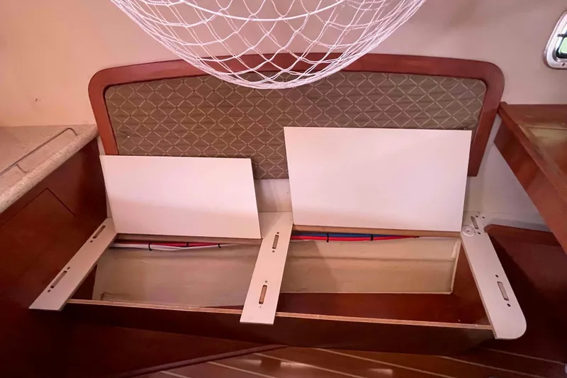 Slide: The Image of Interior of 2010 Hunter 45 Center Cockpit with wooden cabinetry and storage space. - 22