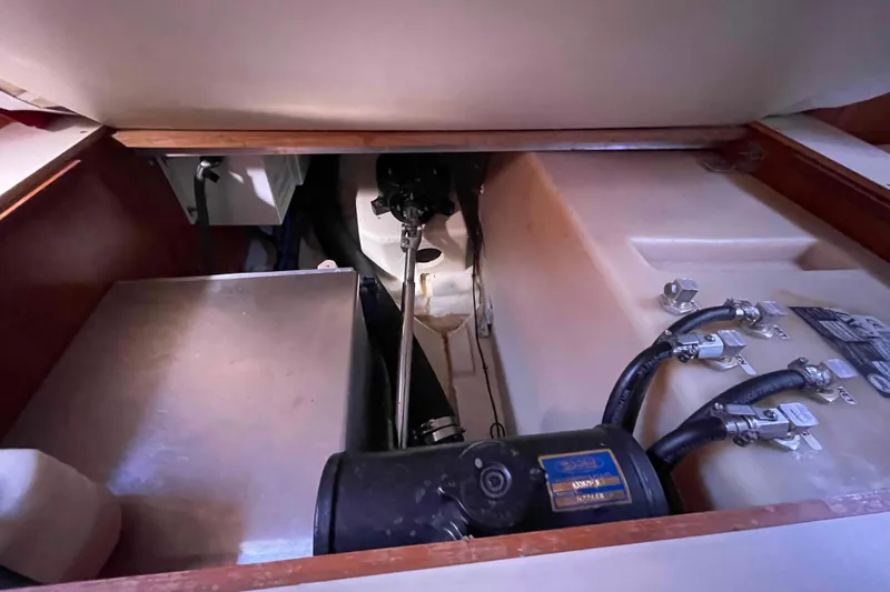 Slide: The Image of Interior of 2010 Hunter 45 Center Cockpit with wooden cabinetry and open storage compartment. - 23