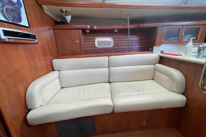 Slide: The Image of Interior of 2010 Hunter 45 Center Cockpit yacht with wood finish and seating area. - 33