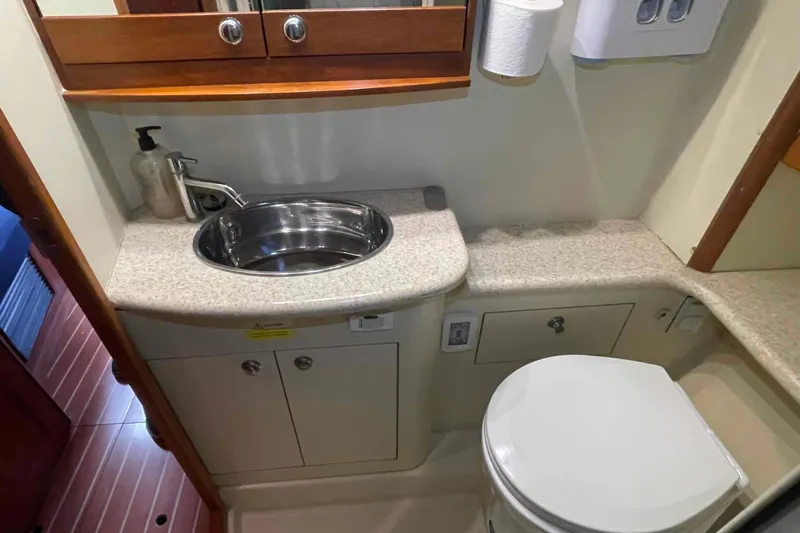 Slide: The Image of Cozy cabin interior of 2010 Hunter 45 Center Cockpit with striped pillows and wood paneling. - 38