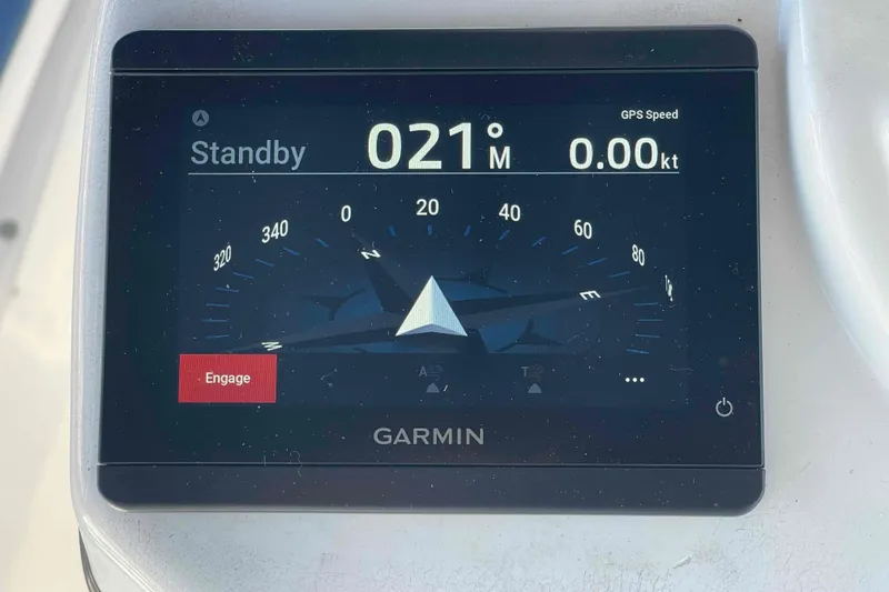 Slide: The Image of 2010 Hunter 45 Center Cockpit sailboat docked in marina, featuring spacious cockpit and sleek design. - 50