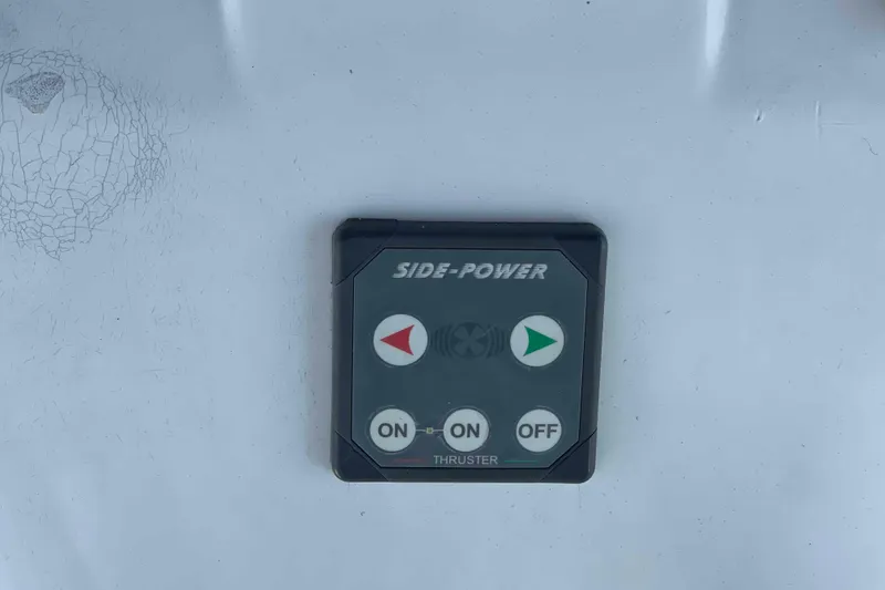 Slide: The Image of 2010 Hunter 45 Center Cockpit sailboat interior with striped seating and navigation equipment. - 52