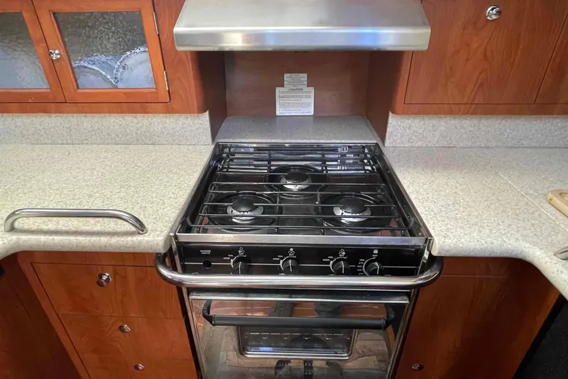 Slide: The Image of Modern kitchen in 2010 Hunter 45 Center Cockpit yacht with wood cabinetry and stainless steel sink. - 6