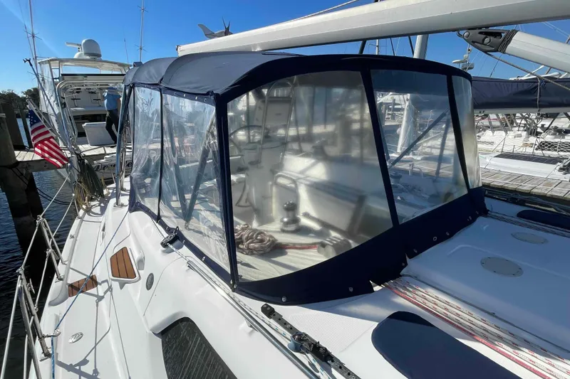 Slide: The Image of 2010 Hunter 45 Center Cockpit sailboat docked at marina, sunny day reflections on water. - 76