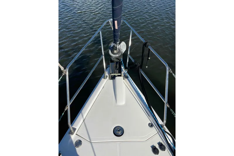 Slide: The Image of 2010 Hunter 45 Center Cockpit sailboat docked at marina, clear canopy visible. - 78