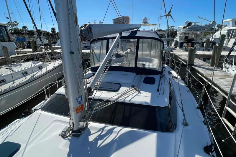 Slide: The Image of 2010 Hunter 45 Center Cockpit sailboat with enclosed cockpit, docked at marina. - 81