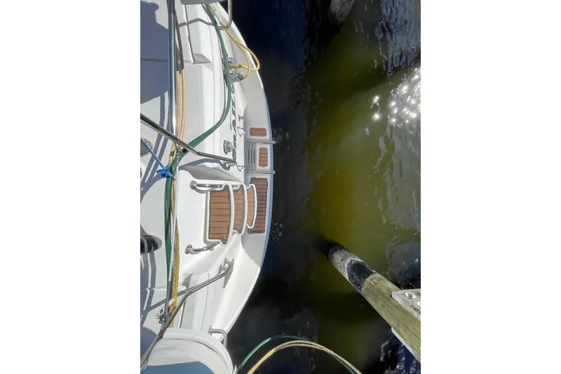 Slide: The Image of Bow of 2010 Hunter 45 Center Cockpit sailboat on calm water. - 83