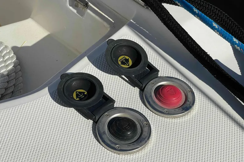 Slide: The Image of Deck controls on a 2010 Hunter 45 Center Cockpit sailboat, featuring anchor and power buttons. - 85