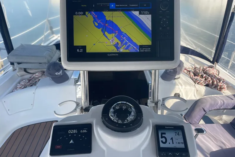 Slide: The Image of Cockpit of 2010 Hunter 45 Center Cockpit sailboat with navigation equipment and compass. - 92