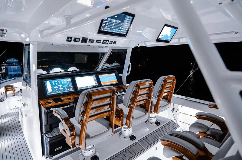 Slide: The Image of Manufacturer Provided Image: 2025 Everglades 455 Center Console boat interior with advanced navigation screens and seating. - 4