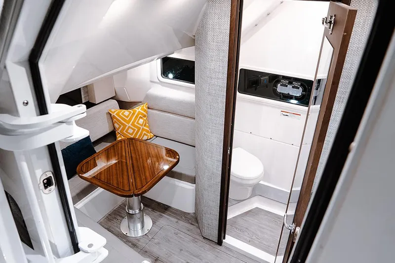 Slide: The Image of Manufacturer Provided Image: 2025 Everglades 455 Center Console cabin interior with table and seating. - 9