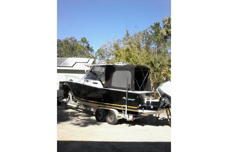 Slide: The Image of 2002 Albemarle 265 Express Fisherman boat with dual outboard motors on a trailer. - 2