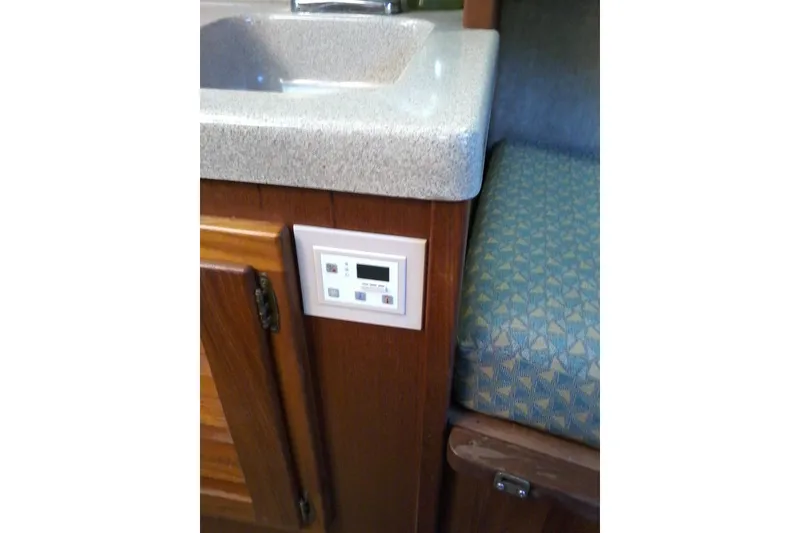Slide: The Image of 2002 Albemarle 265 Express Fisherman cabin interior with sink and control panel. - 21
