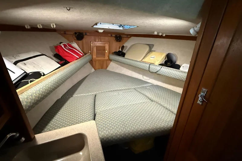 Slide: The Image of 2002 Albemarle 265 Express Fisherman cabin interior with bed and storage compartments. - 24