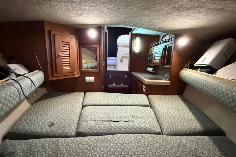Slide: The Image of Interior cabin of 2002 Albemarle 265 Express Fisherman with cushioned seating and wooden cabinetry. - 27