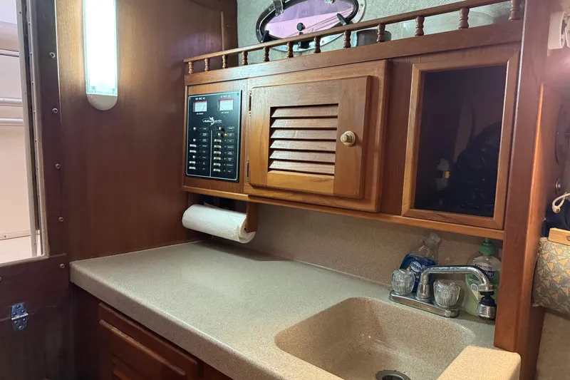 Slide: The Image of Interior of 2002 Albemarle 265 Express Fisherman with wooden cabinetry and sink. - 28