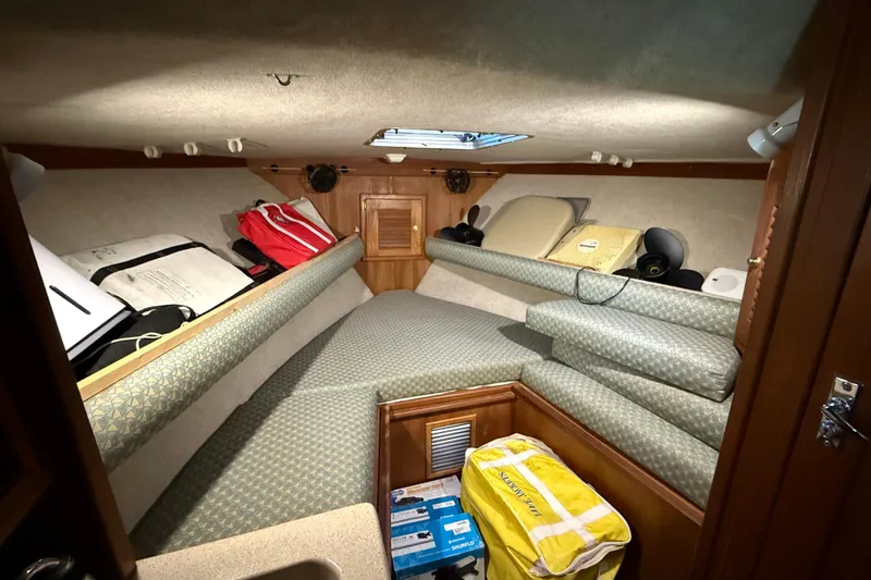 Slide: The Image of 2002 Albemarle 265 Express Fisherman cabin interior with cushions and storage. - 29