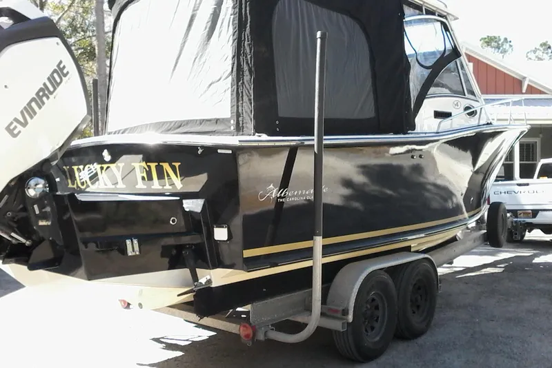 Slide: The Image of 2002 Albemarle 265 Express Fisherman boat on trailer, surrounded by trees. - 5