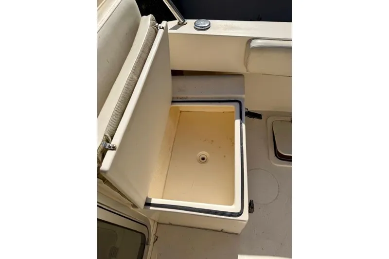 Slide: The Image of Open storage compartment on 2015 Defiance 220 Admiral EX boat. - 14