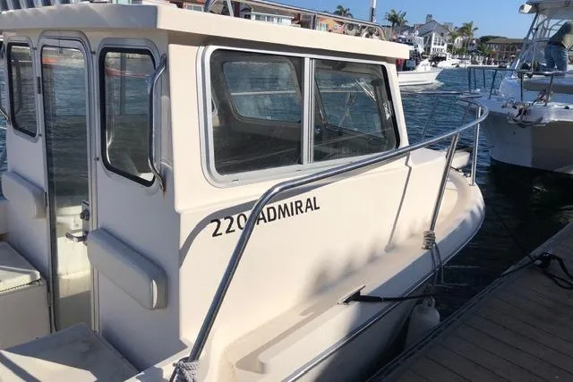 Slide: The Image of 2015 Defiance 220 Admiral EX boat docked in a marina. - 6