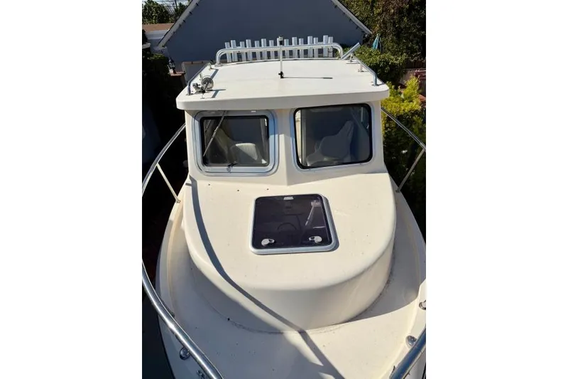 Slide: The Image of 2015 Defiance 220 Admiral EX boat with cabin and rooftop rod holders. - 10