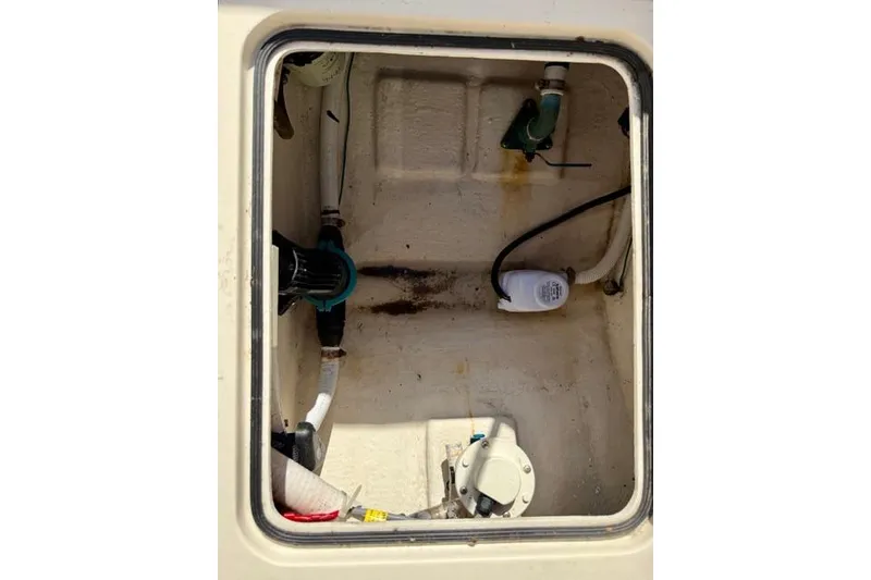 Slide: The Image of 2015 Defiance 220 Admiral EX boat compartment with visible plumbing and wiring. - 13