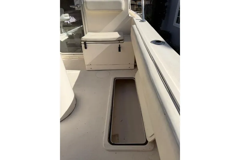 Slide: The Image of Interior of 2015 Defiance 220 Admiral EX boat, featuring seating and storage compartments. - 17