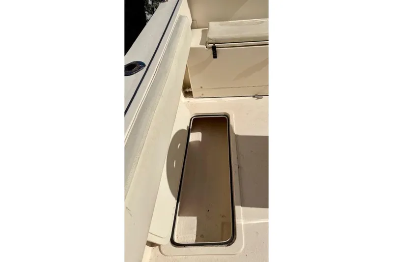 Slide: The Image of 2015 Defiance 220 Admiral EX boat interior with open storage compartment. - 18