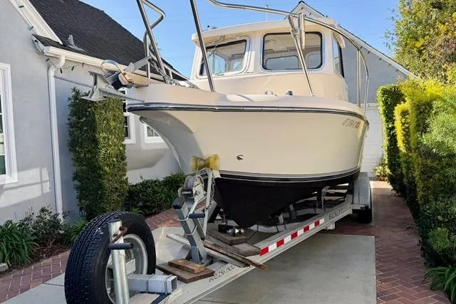 Slide: The Image of 2015 Defiance 220 Admiral EX boat on trailer in residential driveway. - 3