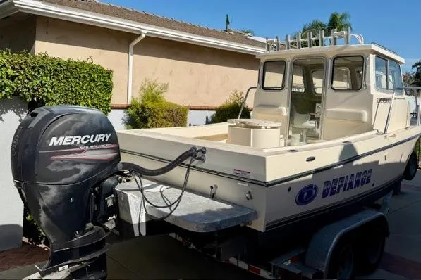 Slide: The Image of 2015 Defiance 220 Admiral EX boat with Mercury outboard motor on trailer. - 4