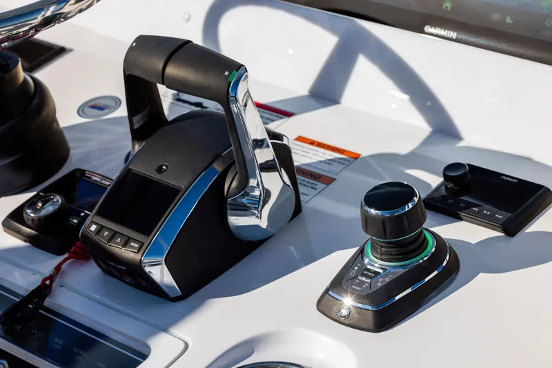 Slide: The Image of Control panel of 2026 Invincible 38 Catamaran featuring advanced navigation and throttle systems. - 12