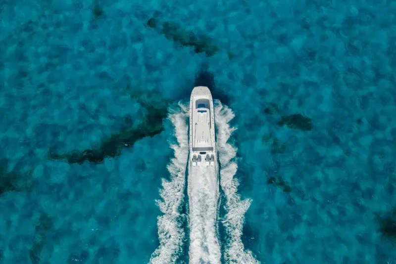 Slide: The Image of Aerial view of 2026 Invincible 38 Catamaran cruising in clear blue waters. - 20