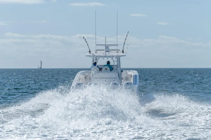 Slide: The Image of Invincible 40 Catamaran 2026 cruising on open sea, creating a dynamic wake. - 12