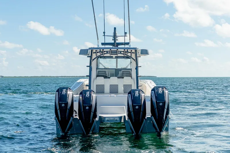 Slide: The Image of Manufacturer Provided Image: 2026 Invincible 46 Pilothouse boat with four engines on open water. - 3