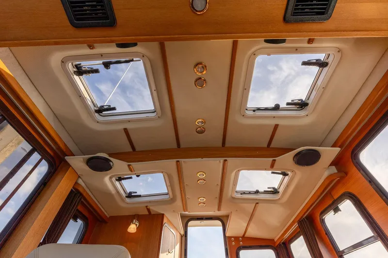 Slide: The Image of Interior ceiling view of 2012 Ranger Tugs R-25 SC with multiple skylights and wooden finish. - 10