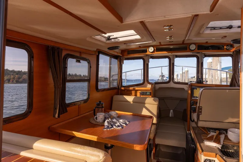 Slide: The Image of Interior of 2012 Ranger Tugs R-25 SC boat with cozy seating and scenic windows. - 6