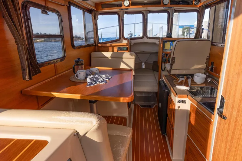 Slide: The Image of Interior of 2012 Ranger Tugs R-25 SC boat with cozy dining and kitchen area. - 7