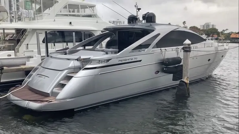The Image of 2015 Pershing 70 luxury yacht docked at harbor. - 0