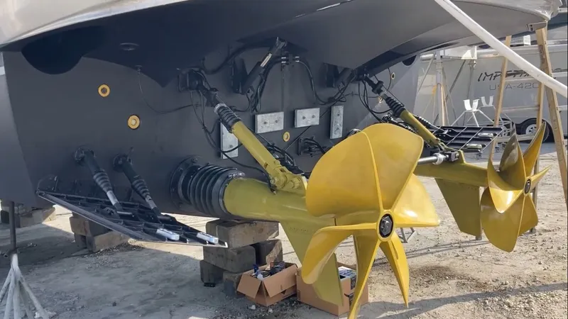 Slide: The Image of Rear view of a 2015 Pershing 70 boat with yellow propellers. - 15