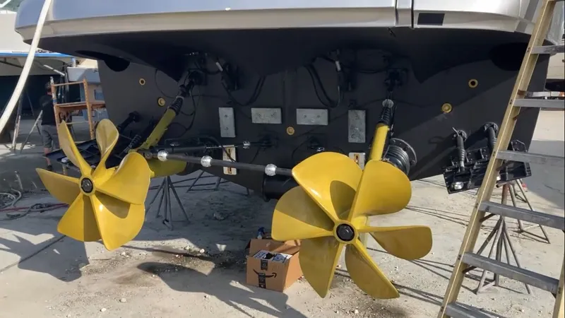 Slide: The Image of Rear view of a 2015 Pershing 70 boat with yellow propellers. - 16