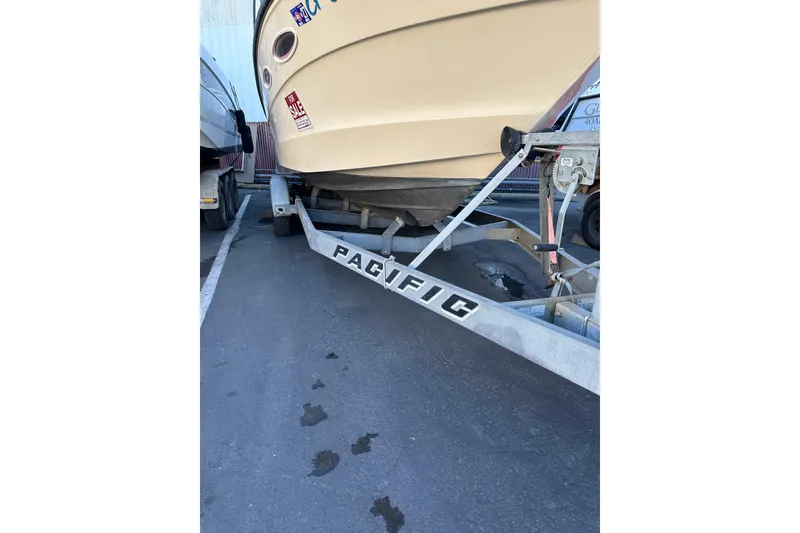 Slide: The Image of 1985 Sea Ray 255 SVR boat on a Pacific trailer in a parking lot. - 10