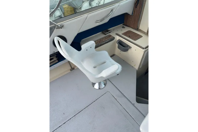 Slide: The Image of White captain's chair on 1985 Sea Ray 255 SVR boat deck. - 3
