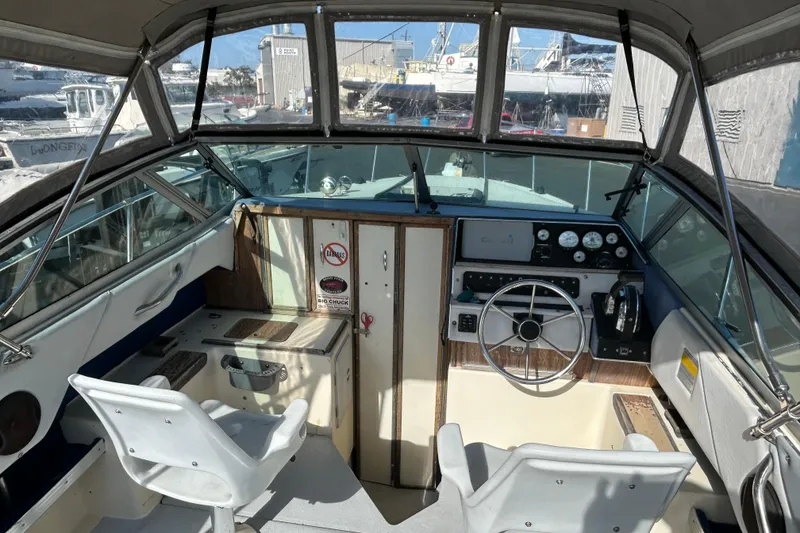 Slide: The Image of Interior view of 1985 Sea Ray 255 SVR boat cockpit with steering wheel and controls. - 7
