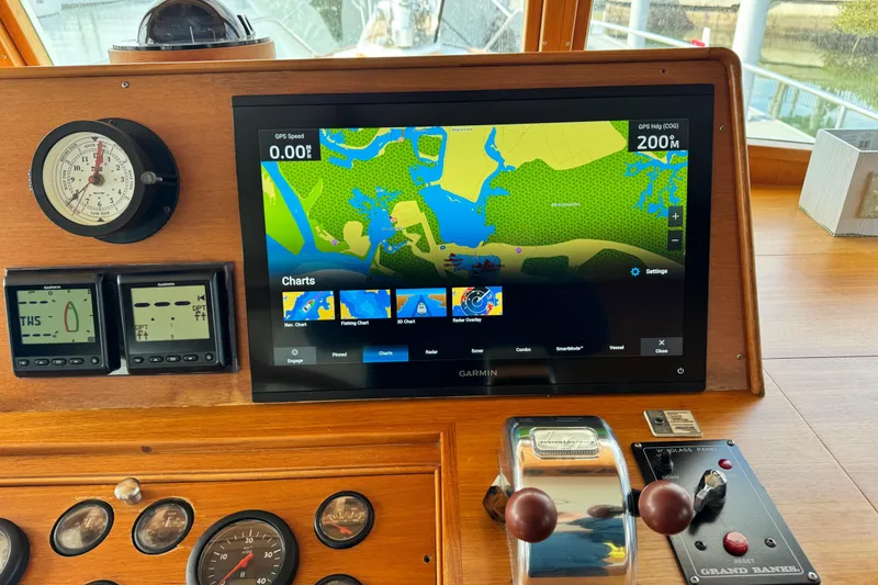 Slide: The Image of Navigation dashboard of a 2000 Grand Banks 52 Europa with Garmin display and controls. - 13