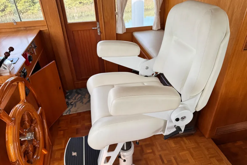 Slide: The Image of Captain's chair and helm on 2000 Grand Banks 52 Europa yacht. - 17