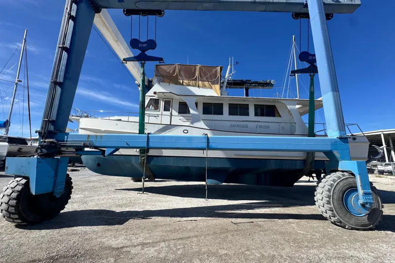 Slide: The Image of Grand Banks 52 Europa 2000 yacht on a lift at a marina, clear blue sky. - 21